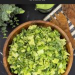 Green Goddess Salad in a wooden bowl with Napa cabbage, spinach, arugula, cucumbers, snow peas, and creamy herb dressing.