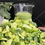 Green Goddess Salad in a black bowl with Napa cabbage, spinach, arugula, cucumbers, snow peas, and creamy herb dressing.