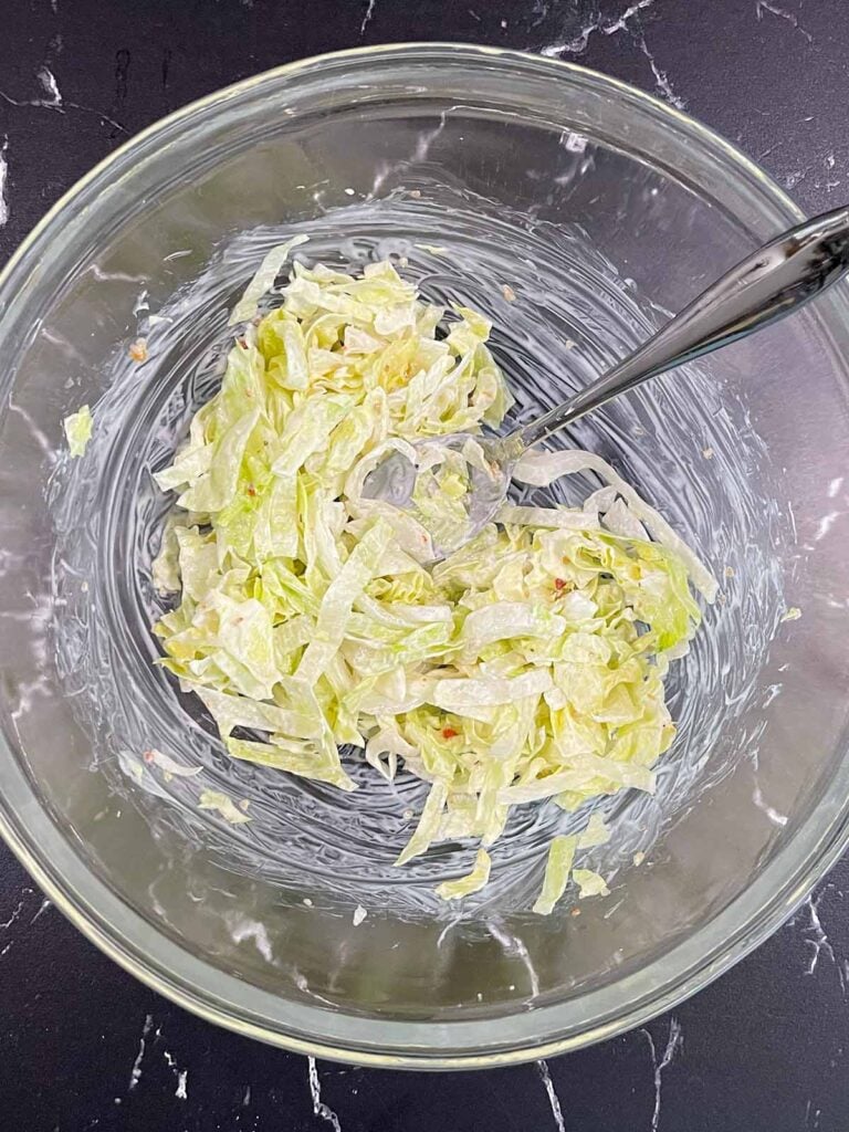 A lettuce mixture in a glass bowl