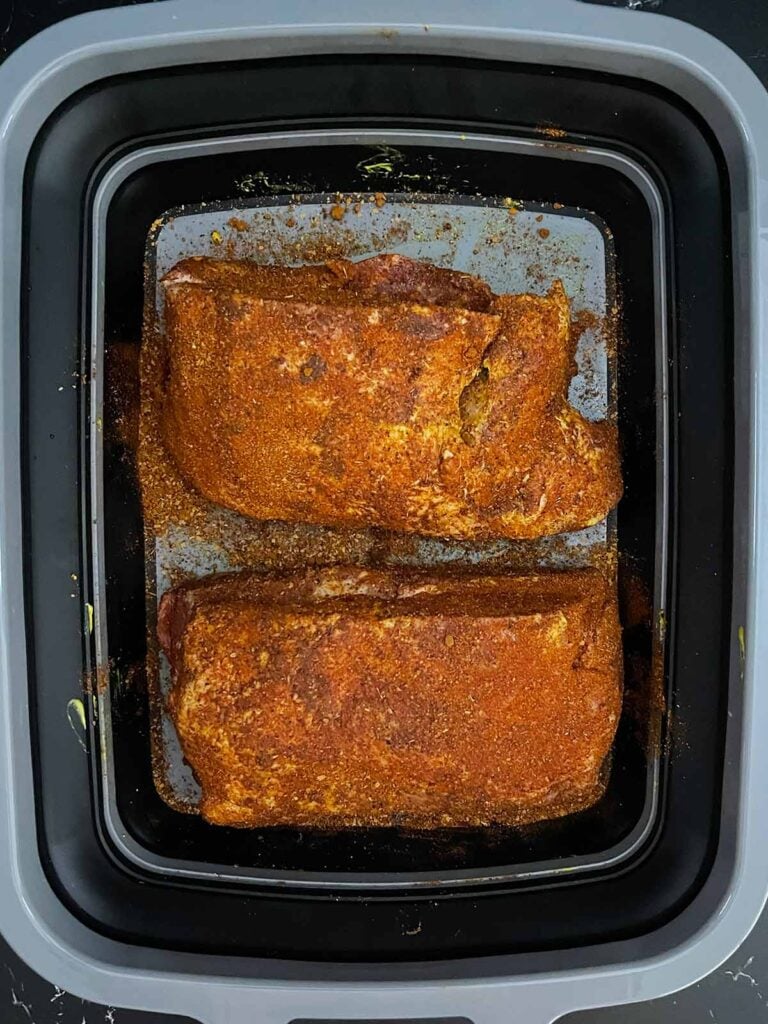 Boneless pork butt halves coated with homemade BBQ rub and ready for the smoker.