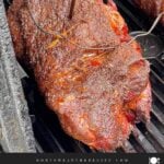 Close-up of smoked boneless pork butt with a deep mahogany bark forming.