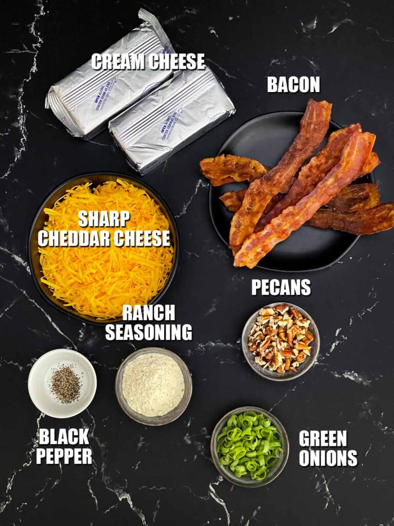 Ingredients for making a Bacon Cheddar Ranch Cheese Ball including cream cheese, cheddar cheese, ranch seasoning, bacon, pecans, green onions, kosher salt, and pepper.