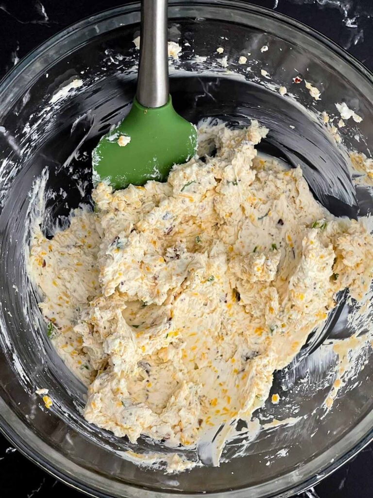 Cream cheese, cheddar cheese, ranch seasoning, black pepper, and bacon mixed together for a Bacon Cheddar Ranch Cheese Ball.
