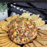 Creamy Bacon Cheddar Ranch Cheese Ball served on a platter with assorted crackers for an easy party appetizer.