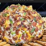 Bacon Cheddar Ranch Cheese Ball coated with bacon, pecans, cheddar cheese, and green onions served with crackers.