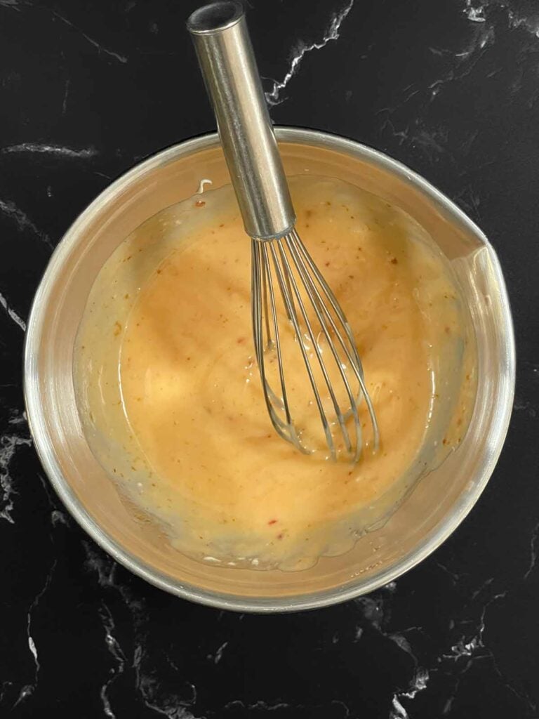 Creamy Bang Bang sauce whisked until smooth with Miracle Whip, sweet chili sauce, sriracha, and rice wine vinegar.