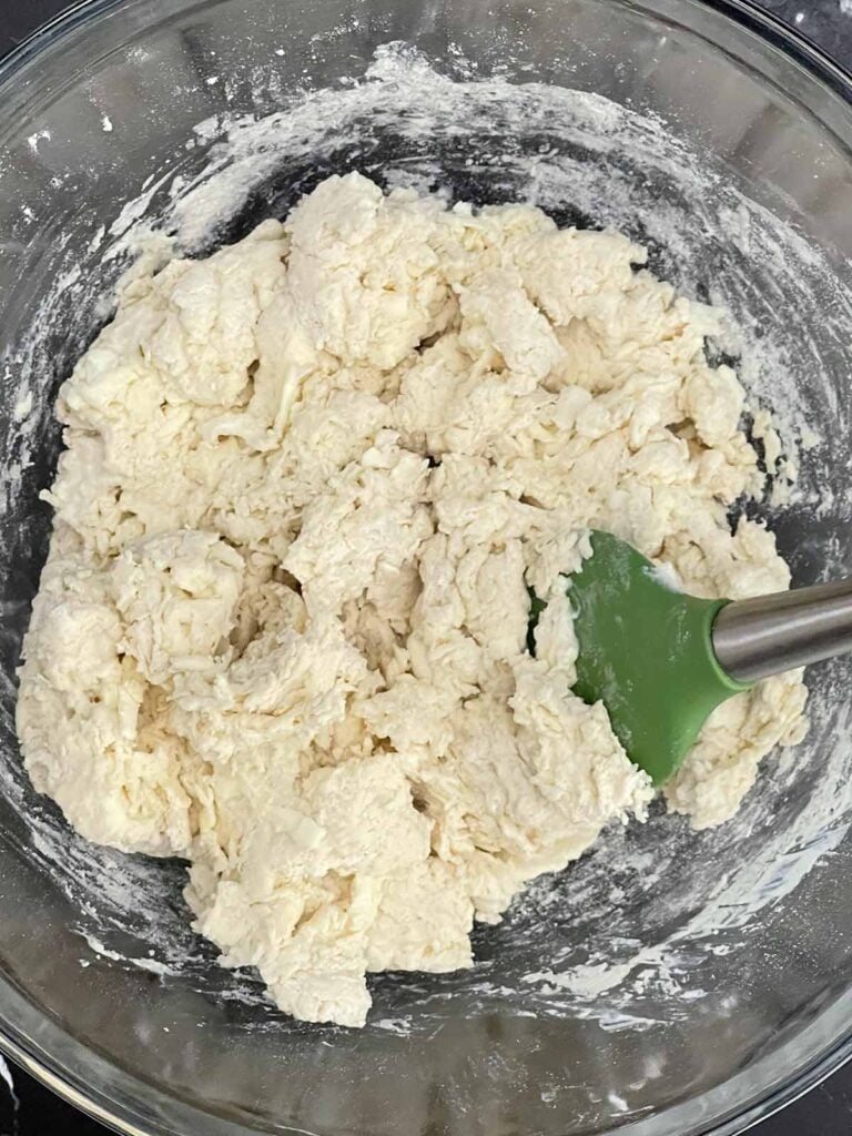 Cold buttermilk stirred into the dry ingredients to form a shaggy biscuit dough.