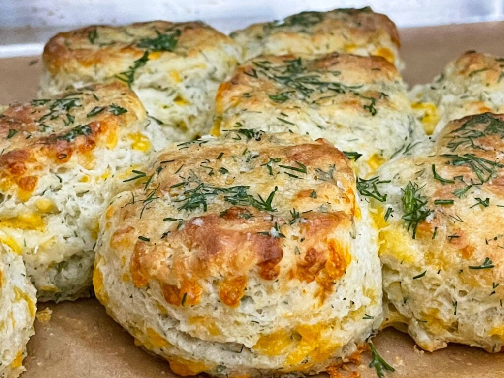 Freshly baked cheddar dill biscuits brushed with garlic dill butter while still warm.