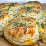 Freshly baked cheddar dill biscuits brushed with garlic dill butter while still warm.