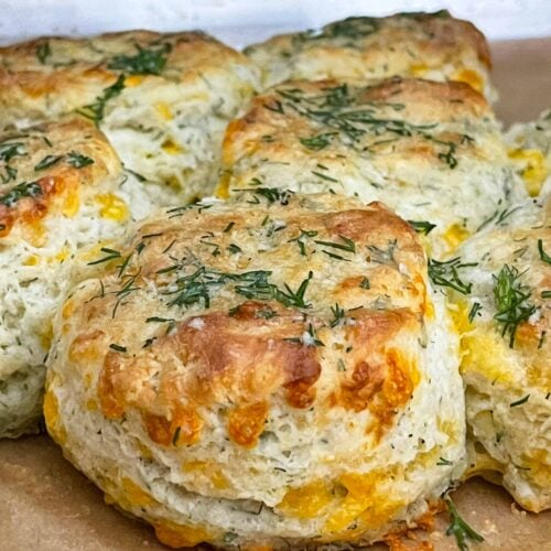 Freshly baked cheddar dill biscuits brushed with garlic dill butter while still warm.