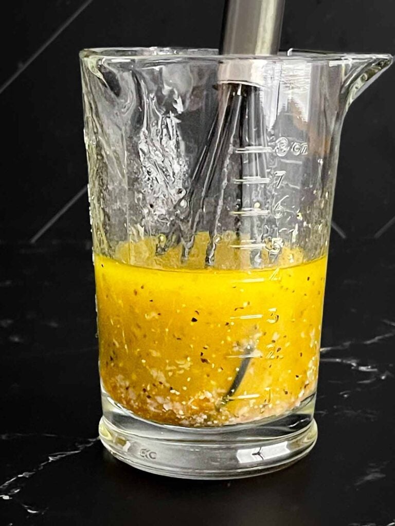 Homemade lime vinaigrette being whisked together for Cowboy Caviar.