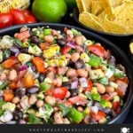 Colorful Cowboy Caviar made with black beans, black-eyed peas, corn, tomatoes, peppers, and cilantro.