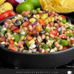 Cowboy Caviar made with black beans, black-eyed peas, corn, tomatoes, peppers, and cilantro.
