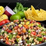 Cowboy Caviar made with black beans, black-eyed peas, corn, tomatoes, peppers, and cilantro.
