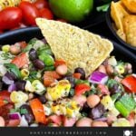 Serving bowl of Easy Cowboy Caviar served with tortilla chips for dipping.