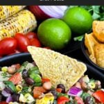 Serving bowl of Easy Cowboy Caviar served with tortilla chips for dipping.