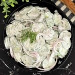 Creamy cucumber salad with fresh dill and red onion ready to serve.