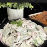 Creamy cucumber salad with fresh dill and red onion ready to serve.