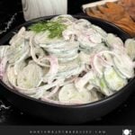 Creamy cucumber salad with fresh dill and red onion ready to serve.