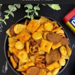 Close-up of crunchy Old Bay Snack Mix made with Corn Chex cereal, pretzels, oyster crackers, and cheddar crackers.