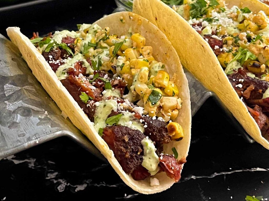 Smoked oxtail tacos in a stand.