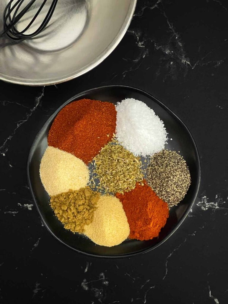 Spices on a dark plate.