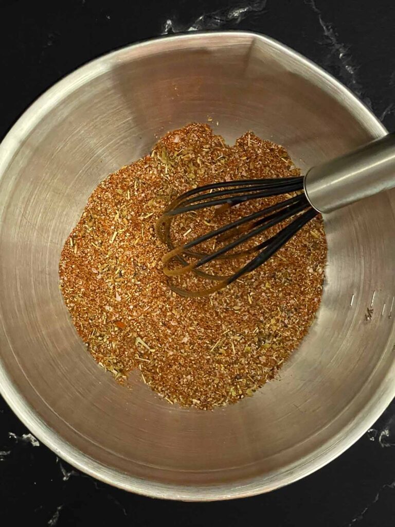 Spices mixed in a stainless steel bowl.