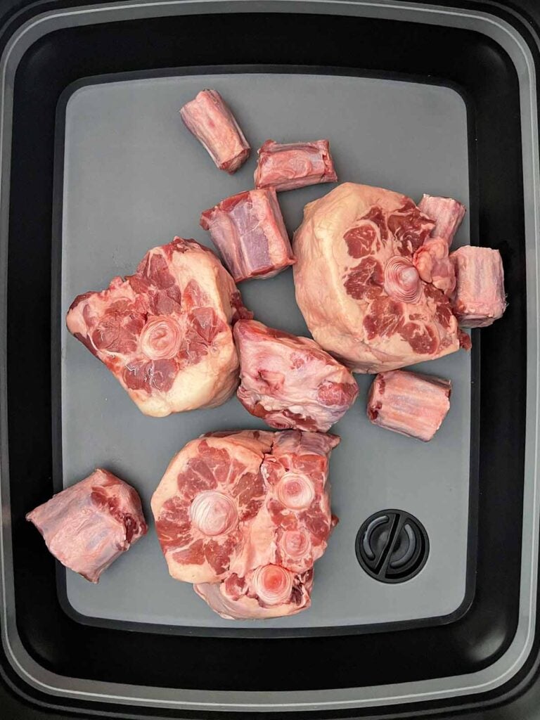 Raw oxtail in a tub.