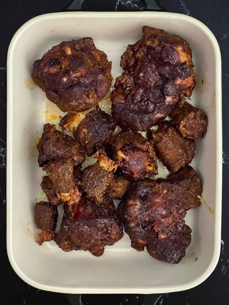 Braised smoked oxtail in a pan.