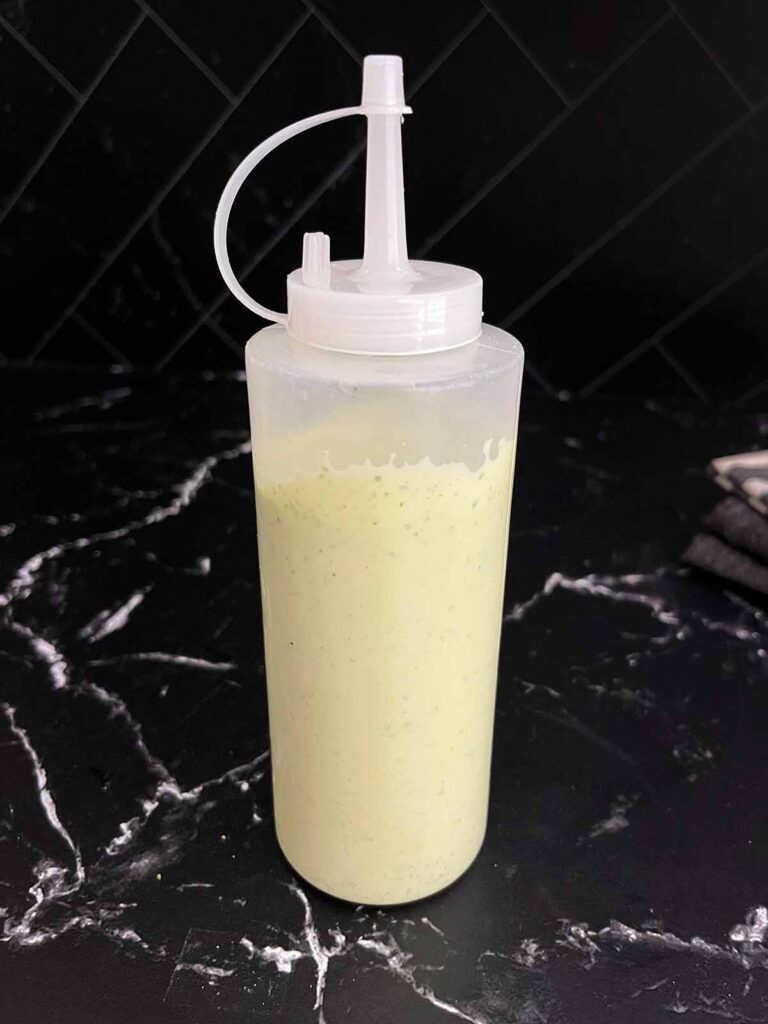 Jalapeno cilantro sauce in a squeeze bottle.