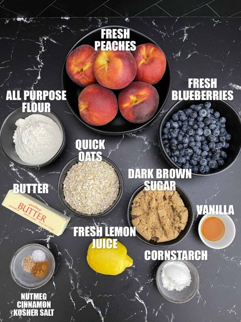 Ingredients for Easy Peach Blueberry Crisp including fresh peaches, blueberries, oats, brown sugar, flour, butter, cinnamon, nutmeg, vanilla, lemon juice, and cornstarch.