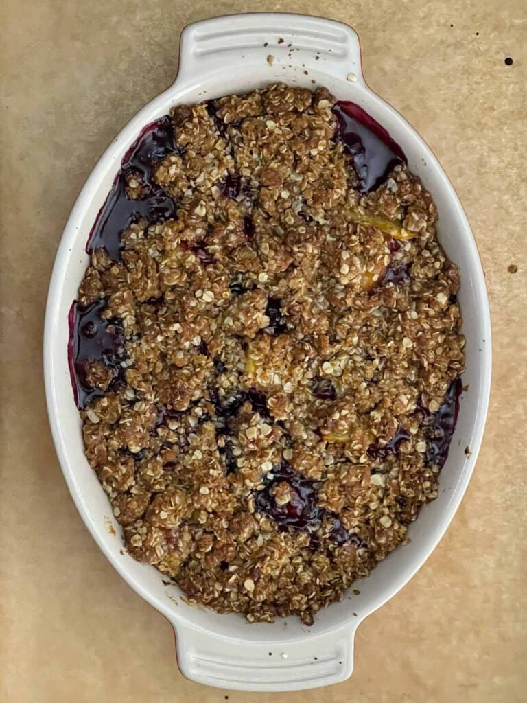 Freshly baked Easy Peach Blueberry Crisp cooling before serving so the fruit filling can thicken.