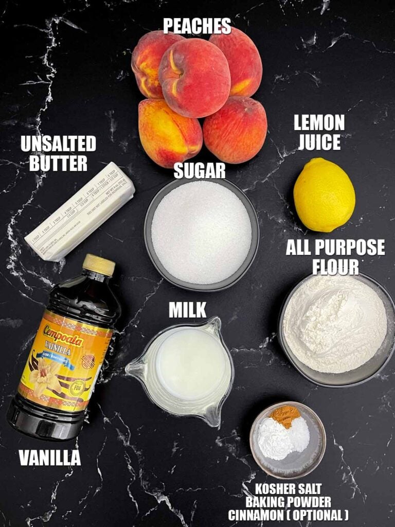 Ingredients for homemade peach cobbler including fresh peaches, butter, flour, sugar, milk, cinnamon, vanilla, baking powder, salt, and lemon juice.