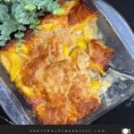 Homemade peach cobbler with a golden buttery crust and juicy peaches fresh from the oven.