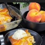 A serving of old-fashioned peach cobbler topped with a scoop of vanilla ice cream.