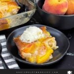 One serving of old-fashioned peach cobbler topped with a scoop of vanilla ice cream.
