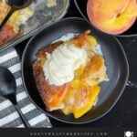 Warm serving of old-fashioned peach cobbler topped with a scoop of vanilla ice cream.