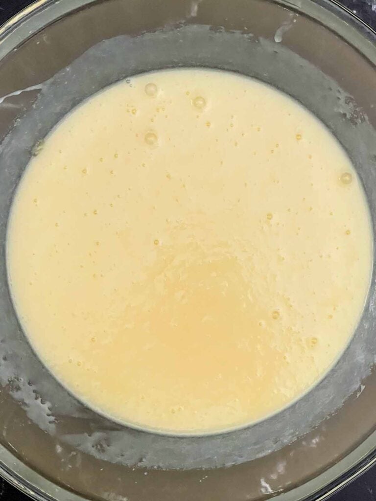 Eggs, sugar, melted butter, buttermilk, peach preserves, vanilla, and almond extract whisked until smooth.