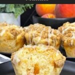 Peach muffin split open to show the soft crumb and juicy peach pieces inside.