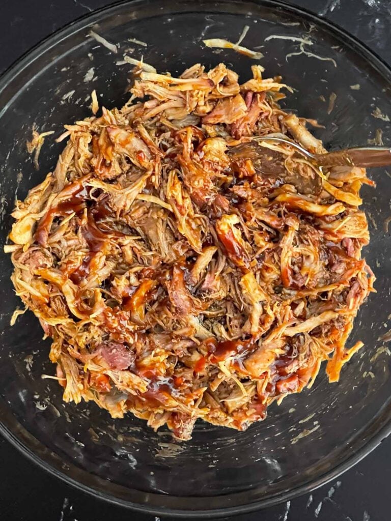 Pulled pork tossed with barbecue sauce until evenly coated.