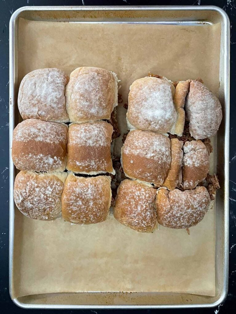 Top half of slider rolls placed over the pulled pork filling.