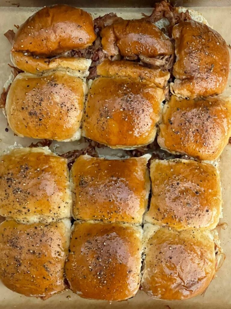 Freshly cracked black pepper sprinkled over buttered slider rolls.