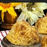 Freshly baked apple cinnamon muffins with tall golden tops in a muffin pan.