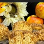 Freshly baked apple cinnamon muffins with tall golden tops in a muffin pan.