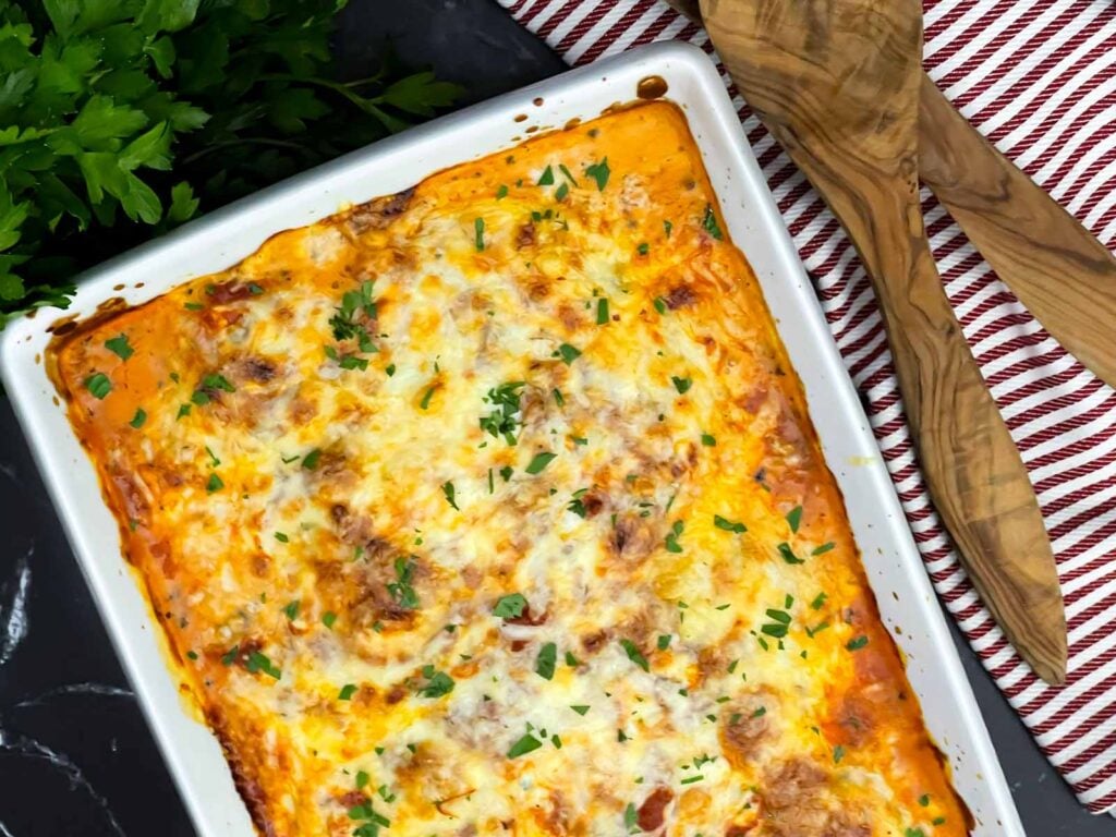 Close-up of baked ricotta chicken with creamy ricotta, marinara sauce, and melted mozzarella cheese.