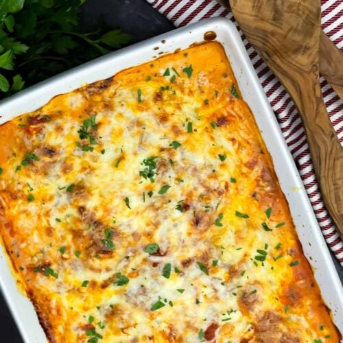 Close-up of baked ricotta chicken with creamy ricotta, marinara sauce, and melted mozzarella cheese.