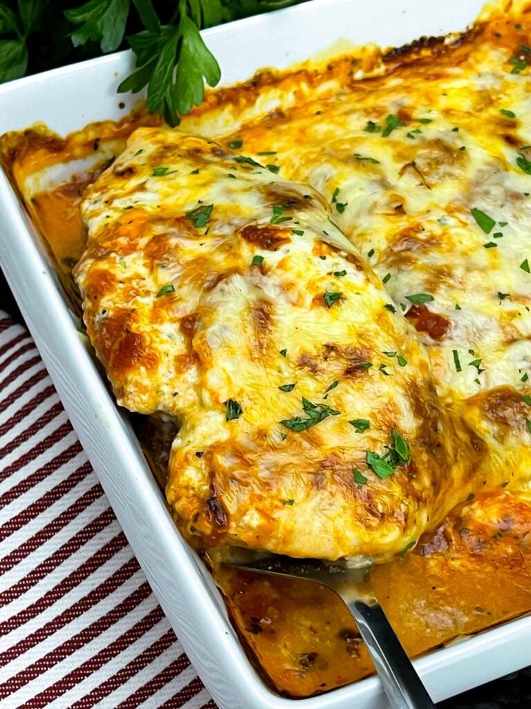 Baked ricotta chicken topped with marinara sauce, melted mozzarella cheese, and fresh parsley.