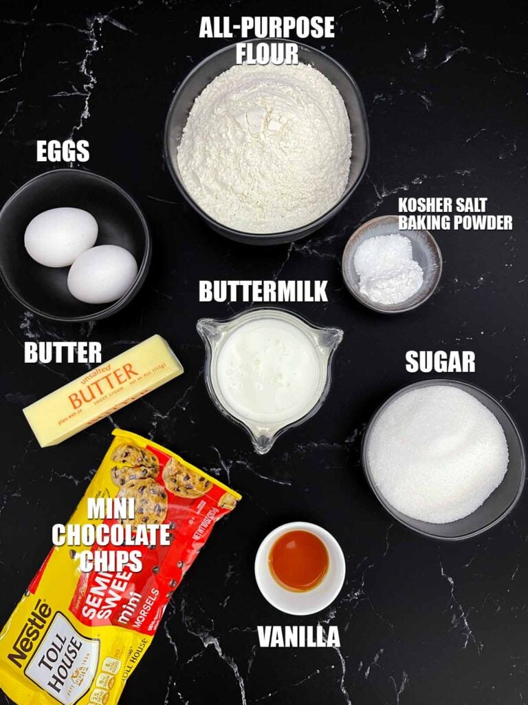 Ingredients for bakery style chocolate chip muffins including flour, butter, eggs, buttermilk, sugar, vanilla, baking powder, salt, and mini chocolate chips.