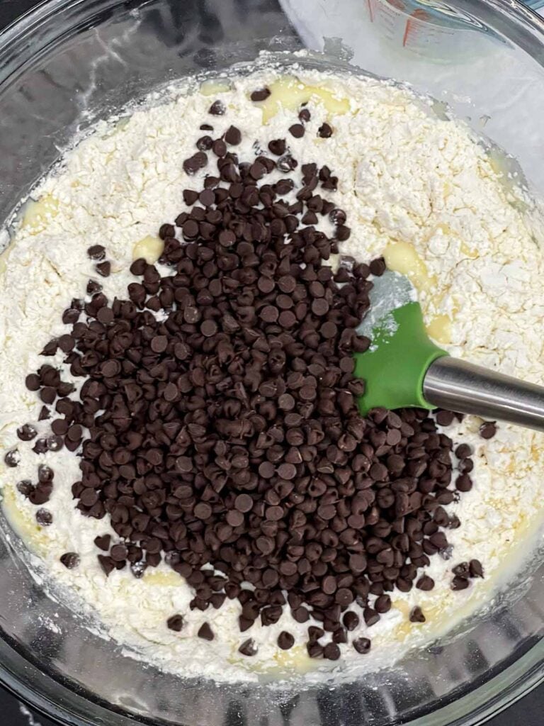 Dry ingredients and mini chocolate chips added to the wet muffin batter.