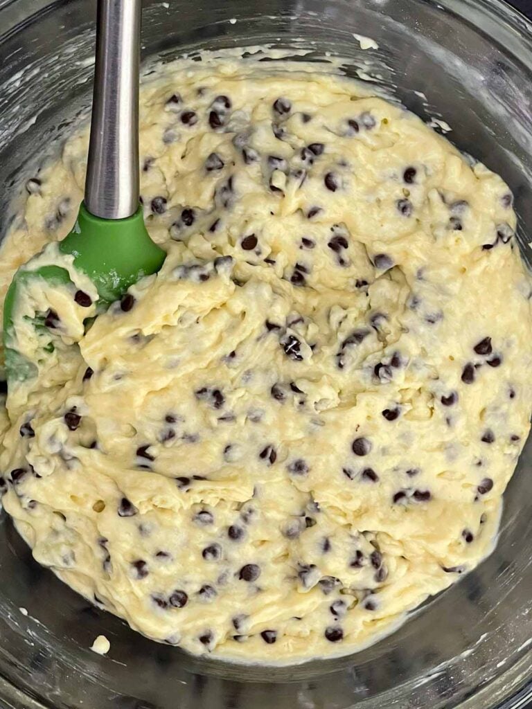 Chocolate chip muffin batter resting in the mixing bowl before baking.